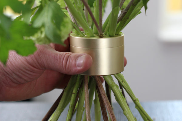 Close up of hand holding a Bouquet Twister Champagne Gold